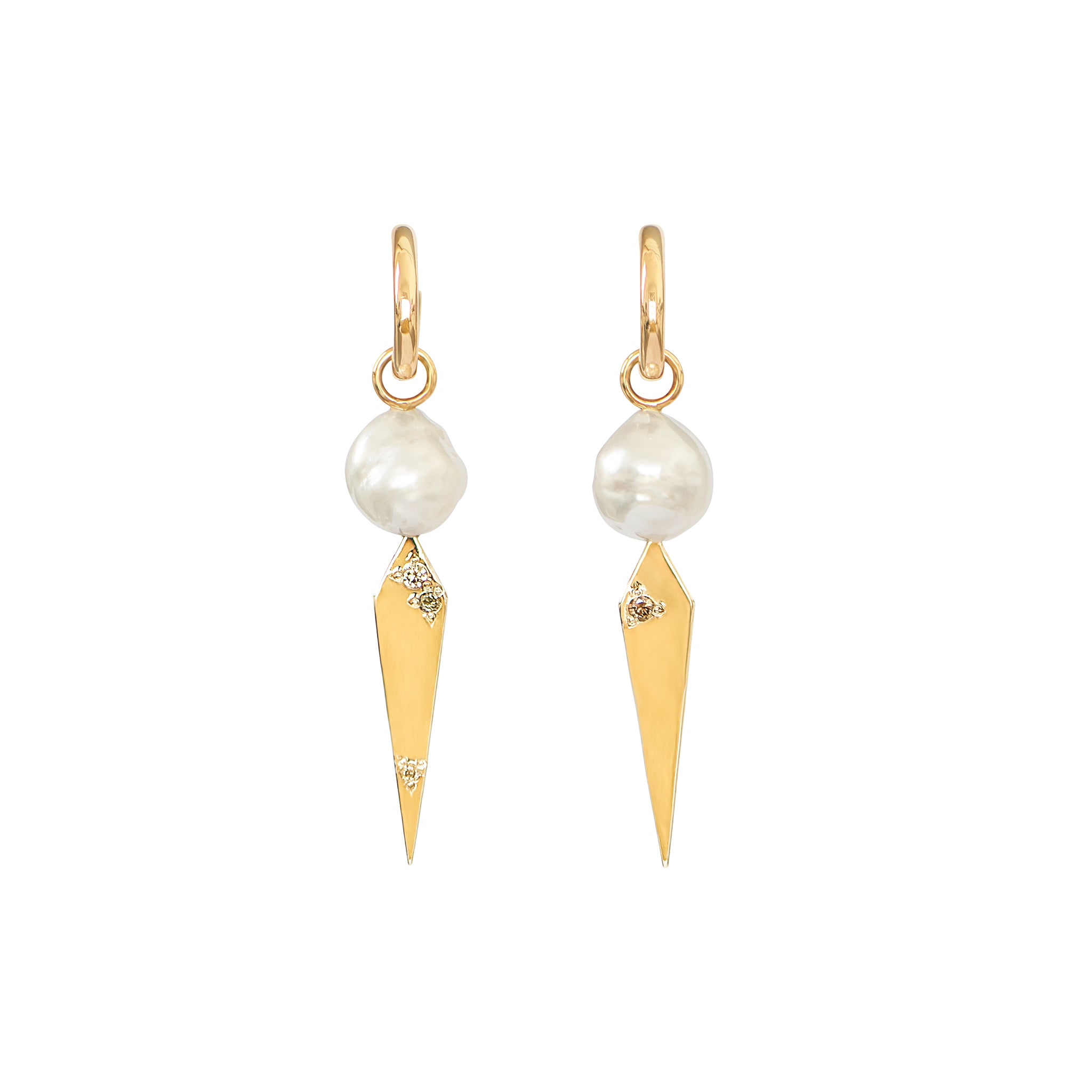 A pair of white baroque South Sea pearl and yellow gold kite shaped drops featuring an earthy mix of Australian champagne diamonds adorn these huggie earrings, displayed on a white background.