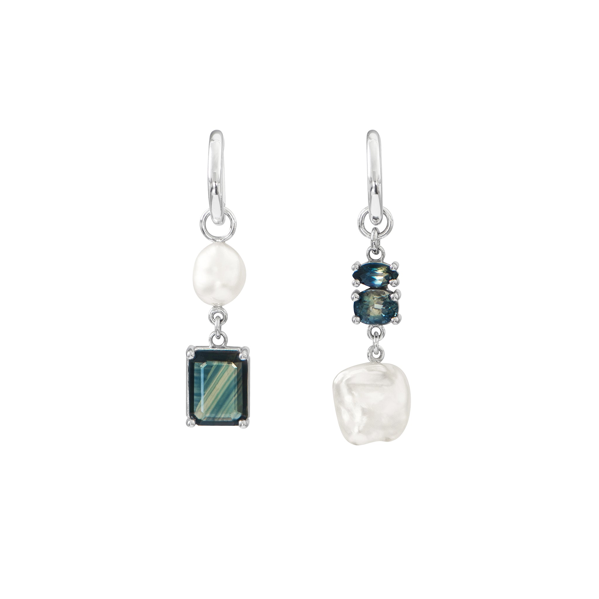 One-of-a-kind white gold huggie earrings are adorned with white Keshi and South Sea pearls, featuring a medley of bi-colour blue Australian sapphires, all hand-selected for their captivating, unique colour banding are displayed on a white background.